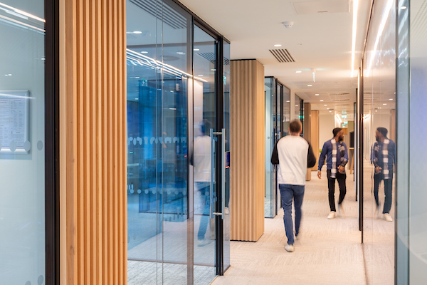 An image of two men walking in an office corridor.